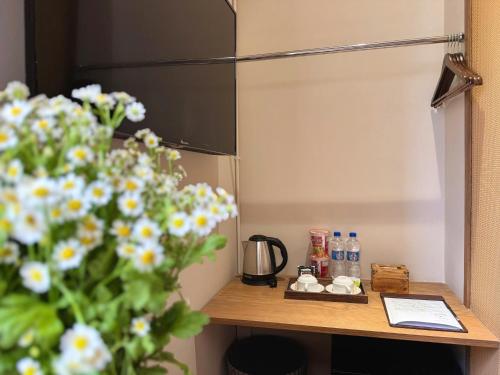 a table in a room with flowers on it at Túi Ba Gang Boutique Hotel in Da Lat