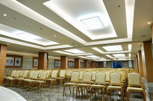 a row of chairs in a room with skylights at Le Royale Palace in kāraikāl
