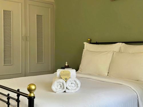 a bedroom with a bed with towels on it at Túi Ba Gang Boutique Hotel in Da Lat