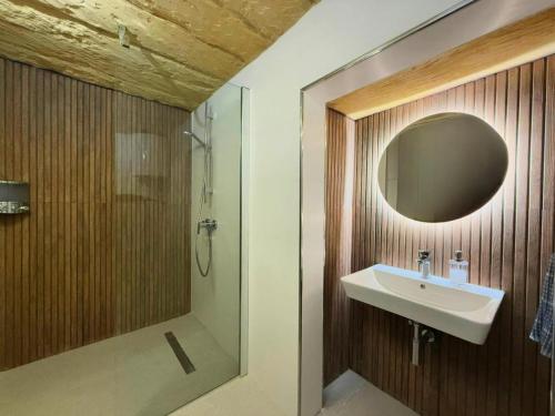 a bathroom with a sink and a shower and a mirror at Traditional House of Character in Gharb Gozo in Għarb