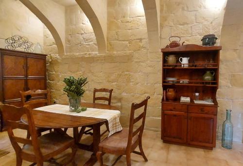 a dining room with a table and some chairs at Traditional House of Character in Gharb Gozo in Għarb