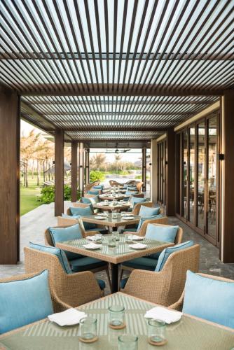 a row of tables and chairs in a restaurant at Maia Resort Quy Nhon in Quy Nhon
