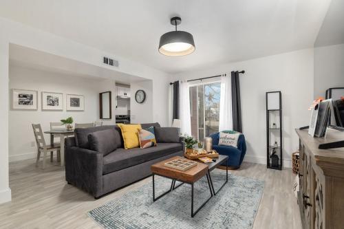 a living room with a couch and a table at Cozy UF Condo - Near Shands UF VA on Archer Road ! in Gainesville
