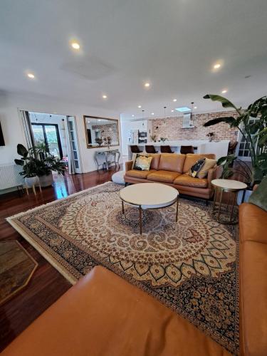a living room with a couch and a table on a rug at Beach House in Perth