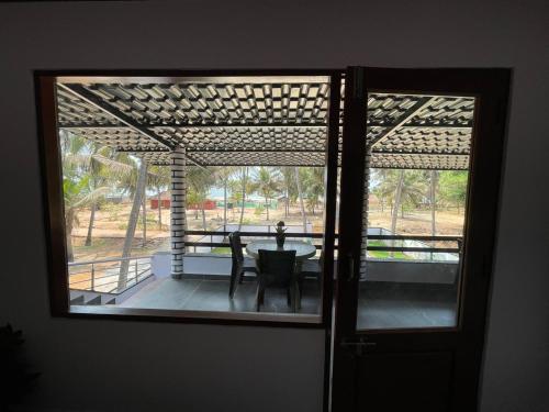 a view of a patio through a glass door at Rock n Ocean1 Beach Stay in Udupi