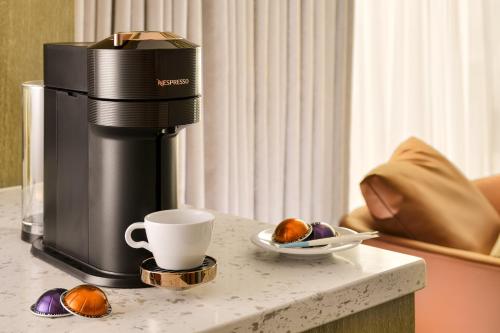 a coffee machine sitting on a table with a cup at JAI Château Hotels & Hostels in Tainan