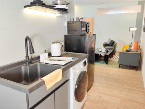 a kitchen with a sink and a counter top at The Tranquil - Bangsar Trade Centre in Kuala Lumpur