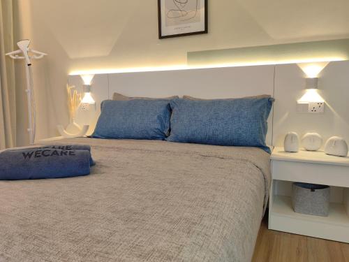 a bedroom with a large bed with blue pillows at The Tranquil - Bangsar Trade Centre in Kuala Lumpur