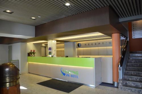 an office lobby with a green and white counter at Viiking Spa Hotel in Pärnu