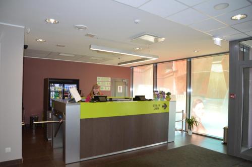 a woman sitting at a counter in an office at Viiking Spa Hotel in Pärnu