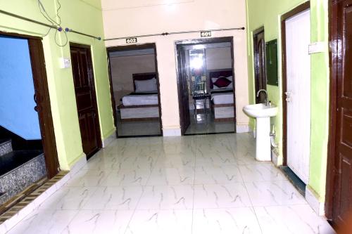 a room with a bathroom with a sink and a toilet at Hotel Shobhani in Deoghar