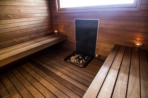 an inside view of a sauna with a fireplace at Naapurivaaran Lomakeskus in Vuokatti