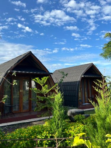 a house with a black roof at KA MANIcamp in Angsri