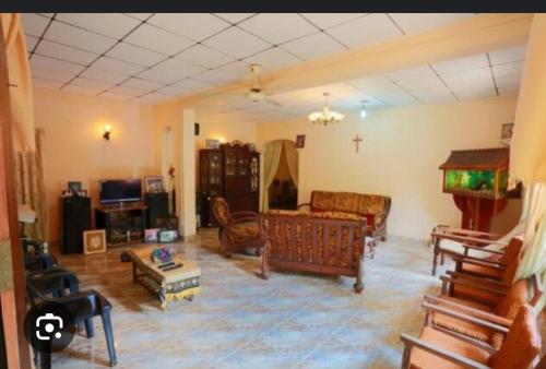 a living room with furniture and a cross on the ceiling at Cinnamon Villa in Seeduwa