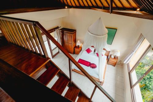 an overhead view of a bedroom with a bed and stairs at Sri Aksata Ubud Resort in Ubud