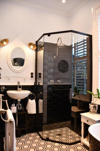 a bathroom with a shower and a sink at Sherwood Park in Spring Terrace