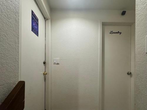 a white elevator with a sign on the door at Garden Suite Two Bedroom with Hot Tub Sauna Outdoor kitchen and Game Room in Everett