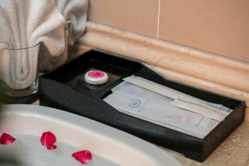 a black box with red roses on top of a sink at Halios Hotel Halong in Ha Long