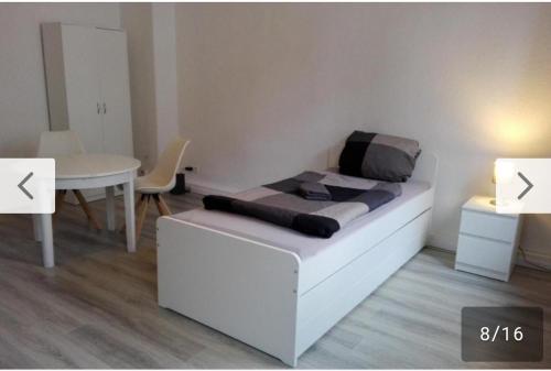 a room with a white couch and a table and a table and a tablektop at Monteurwohnung bei Nina 2OGL in Zeitz