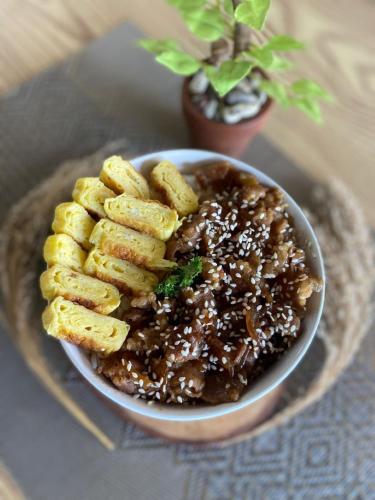 a bowl of food with fries on a plate at ndalem singgah malioboro by abiza in Demangan