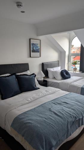 two beds sitting next to each other in a bedroom at Stunning Skyview 2BR flat , fast Wifi - Home Away from Home in Central Station