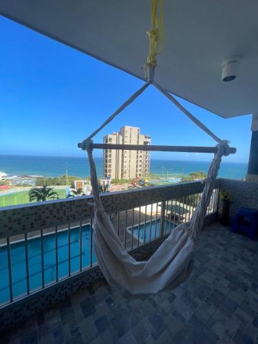 a hammock on a balcony with a view of the ocean at Apartamento VistaMar in La Guaira