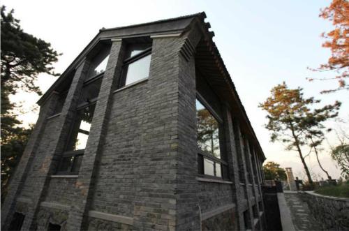 a brick building with windows on the side of it at Home of the Great Wall in Huairou