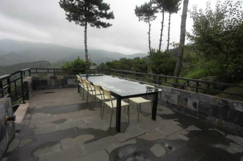 a table and chairs on a patio with a view at Home of the Great Wall in Huairou