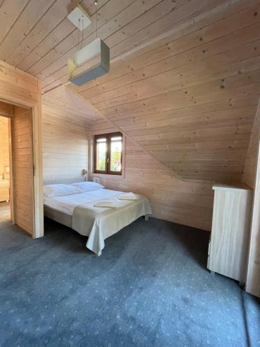 a large wooden room with a bed in it at Villa Roma przy wyciągu na Szrenicę in Szklarska Poręba
