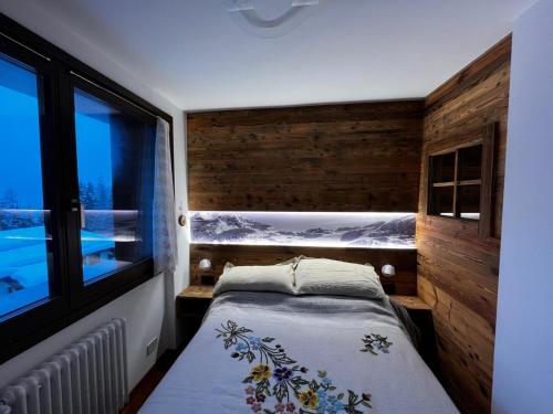 a small bedroom with a bed and a window at LaStubediGió in Folgarida