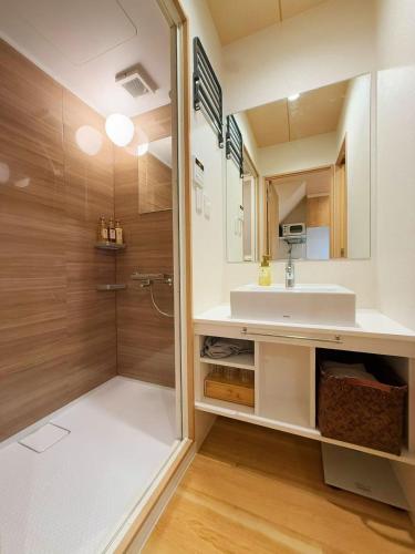 a bathroom with a sink and a shower at M house asakusa kaminarimon tokyo in Tokyo