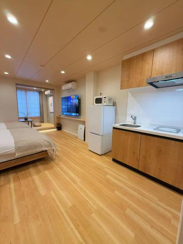 a large room with a bed and a kitchen at M house asakusa kaminarimon tokyo in Tokyo
