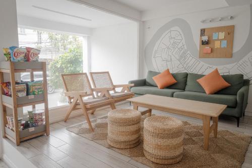 a living room with a green couch and a table at Common Inn Thao Dien in Ho Chi Minh City