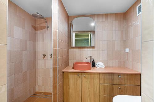a bathroom with a sink and a shower at Viscount on the Beach in Gold Coast
