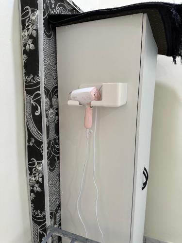 a room with a phone plugged into a wall at Teratak Manis Homestay in Kuantan