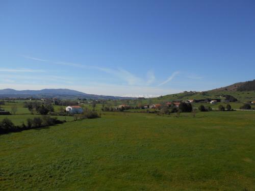 a field of green grass with mountains in the background at Posada Gran Sol in Queveda