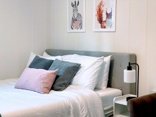 a bedroom with a bed with pillows on it at Redwood Nook - 8 min walk to redwood state park in Felton