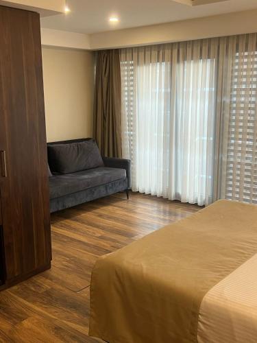 a bedroom with a bed and a couch in a room at The Way Hotel in Istanbul