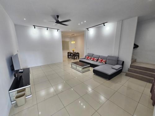 a living room with a couch and a tv at Cahaya Villa 2452 in Miri
