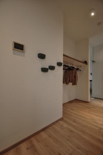 a room with a white wall with shoes on a wall at Cadix 35 in Antwerp