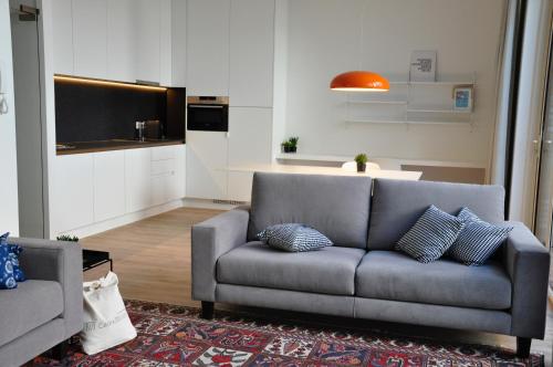 a living room with a couch and a kitchen at Cadix 35 in Antwerp