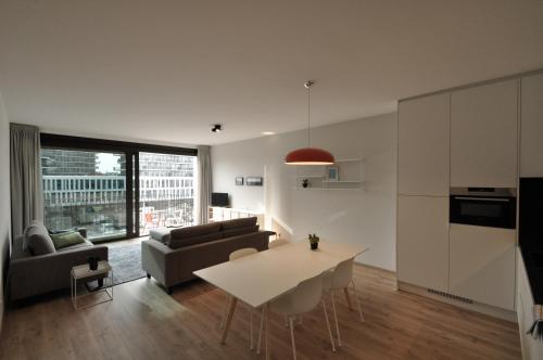 a living room with a couch and a table at Cadix 35 in Antwerp