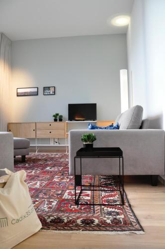 a living room with a couch and a table at Cadix 35 in Antwerp