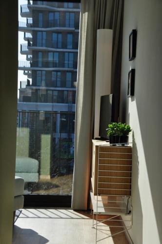 a room with a television on a dresser with a window at Cadix 35 in Antwerp