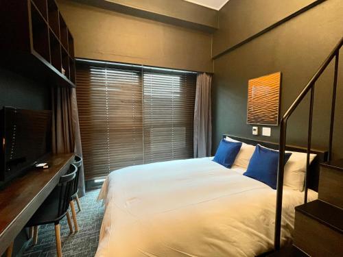 a bedroom with a bed and a desk and a television at Blue Ocean Hotel 4 in Incheon