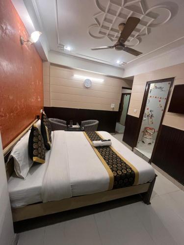 a large bed in a room with a ceiling at द्वारकानाथ hotel in Haridwār