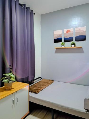 a room with purple curtains and a bed at Sunset Suite Condo Style Stay with Motor Parking in Santo Cristo