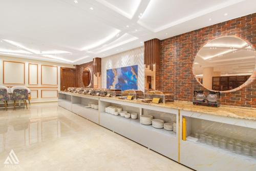 a large room with a counter with a mirror at Arison Luxury in Srinagar