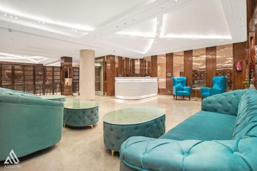 a library with blue furniture and blue chairs at Arison Luxury in Srinagar