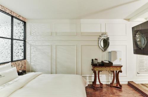 Ein Bett oder Betten in einem Zimmer der Unterkunft Hotel The Class